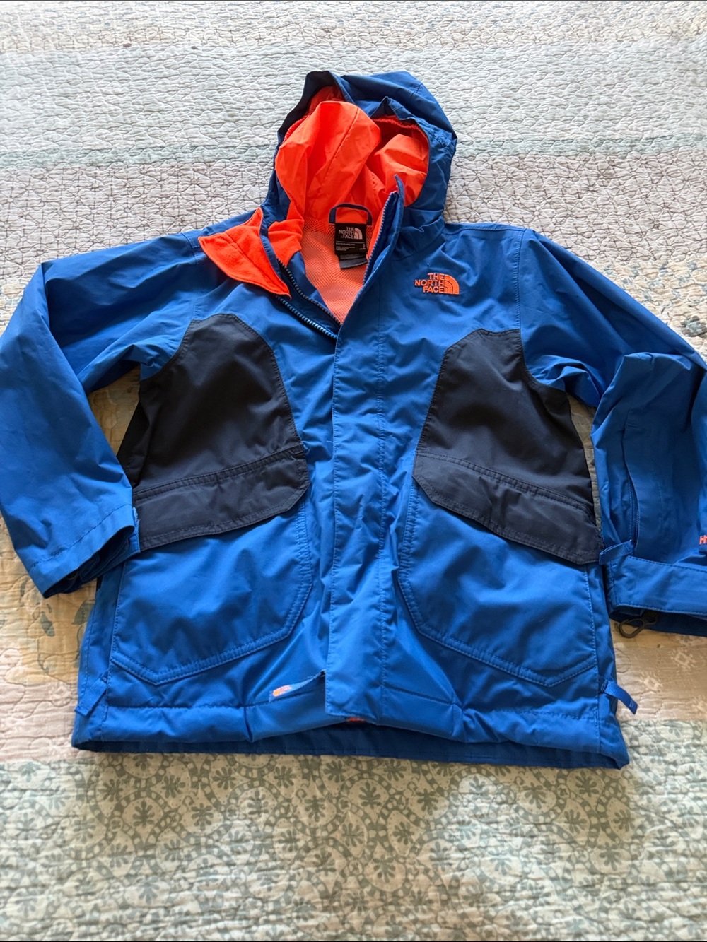The North Face Kids Blue Jacket with Orange Hood Lining